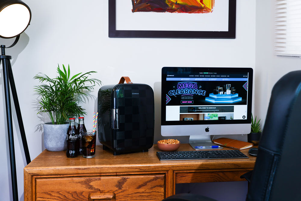 Portable mini fridge on desk, front view with display screen