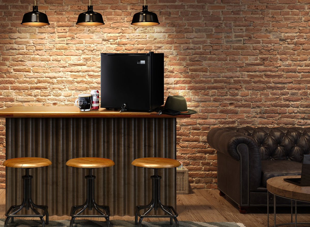 Black mini bar fridge on countertop in a lounge setting, door closed