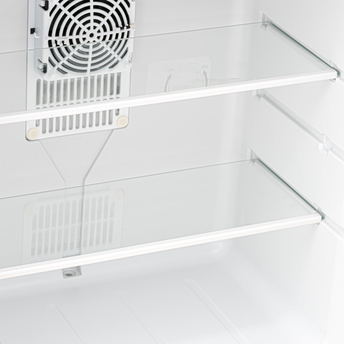 Mini fridge interior with white wire shelves and cooling fan vent