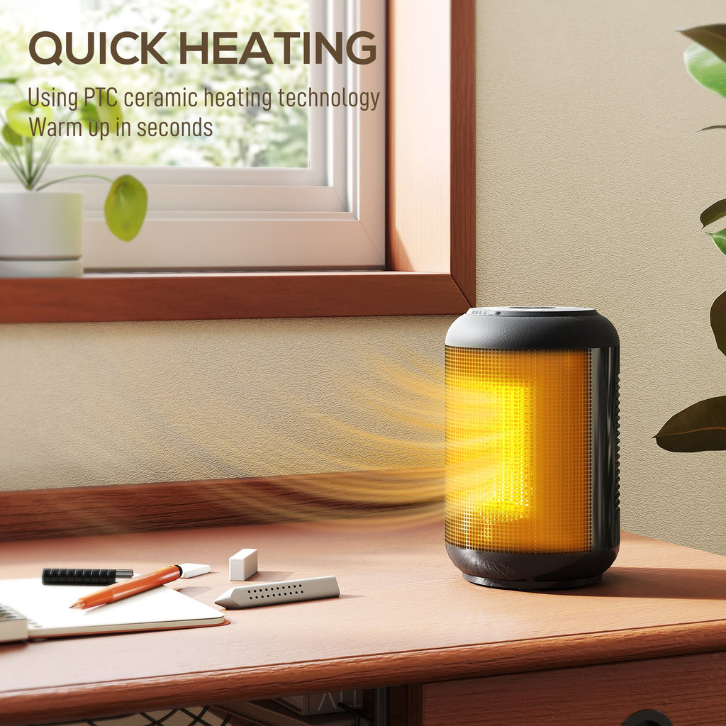 Black ceramic electric heater with glowing amber core on wooden desk