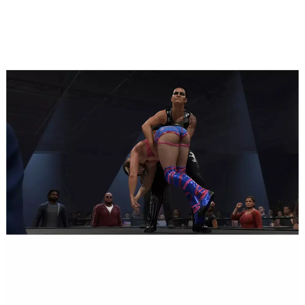 PS5 wrestling video game screen: female wrestler in blue and red ring outfit