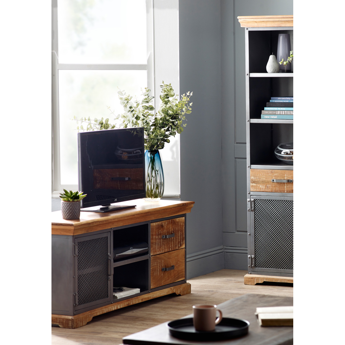 Wood and metal media console with open shelf space, drawer fronts, and mesh door.