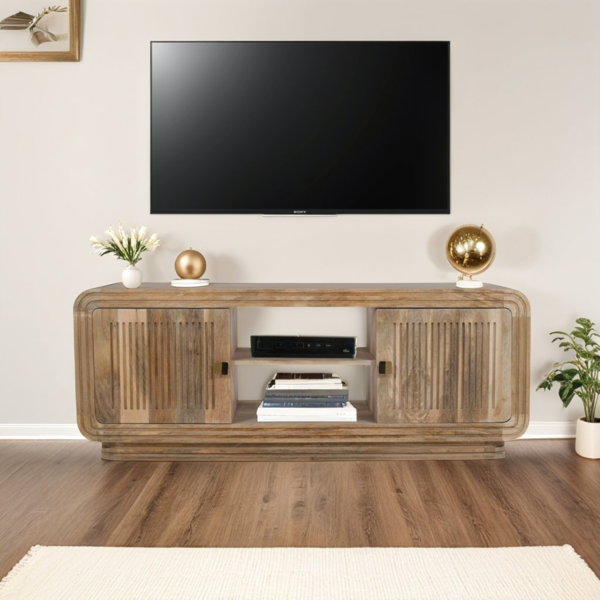 Mango wood TV cabinet with two doors and open center shelf, carved panel fronts.