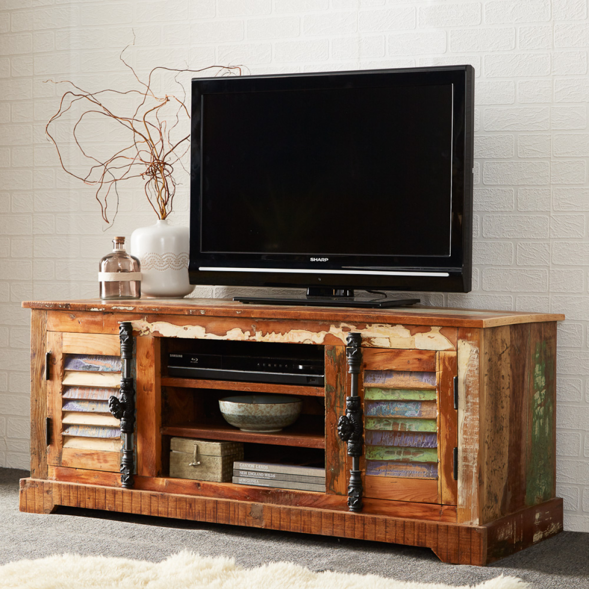Wood TV cabinet with open media shelf, black bar hardware, and lower cabinet space