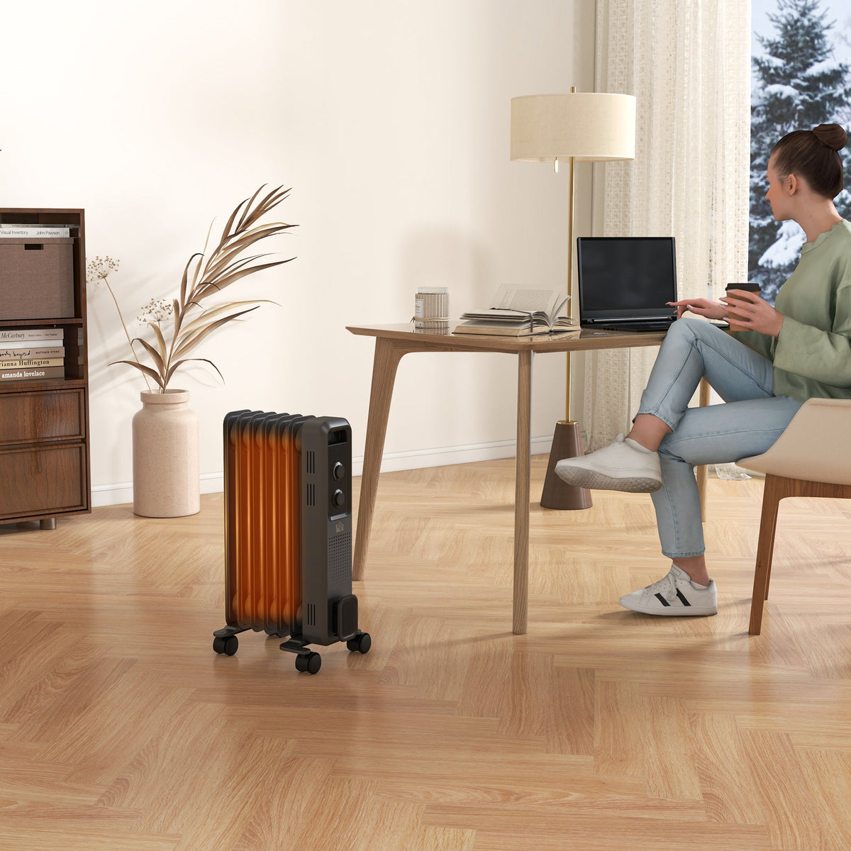 Grey oil-filled radiator heater on wheels near a desk, shown in a wide living-room view