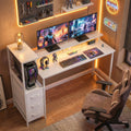 White gaming desk with dual monitor stand, keyboard shelf, and RGB LED lighting