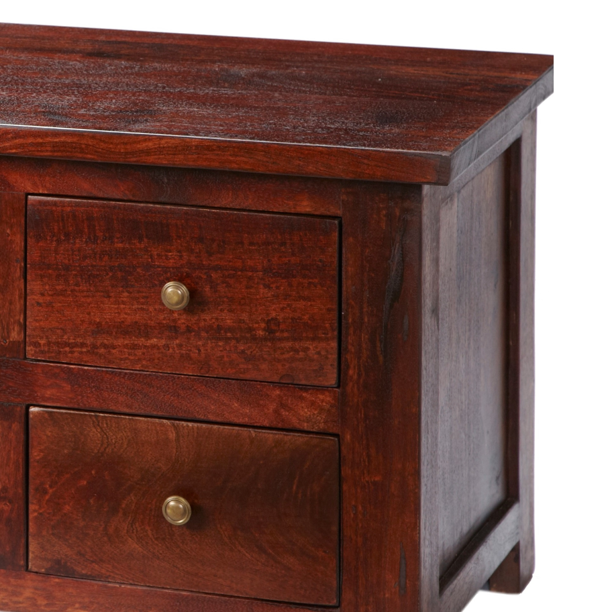 Dark mango cabinet drawer fronts with brass knobs and visible wood-grain texture.