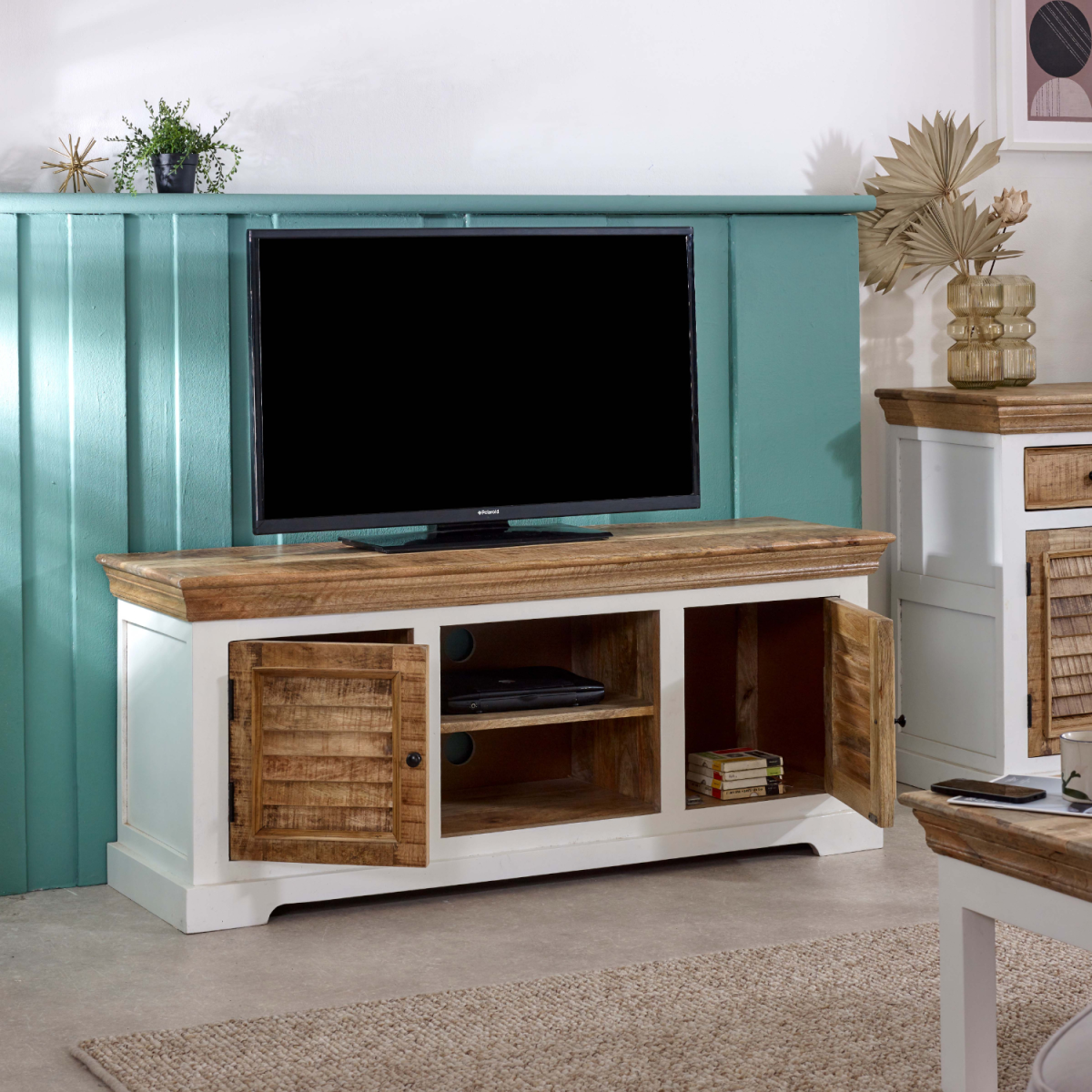 Solid mango wood TV stand with open center media shelf and two closed side doors.