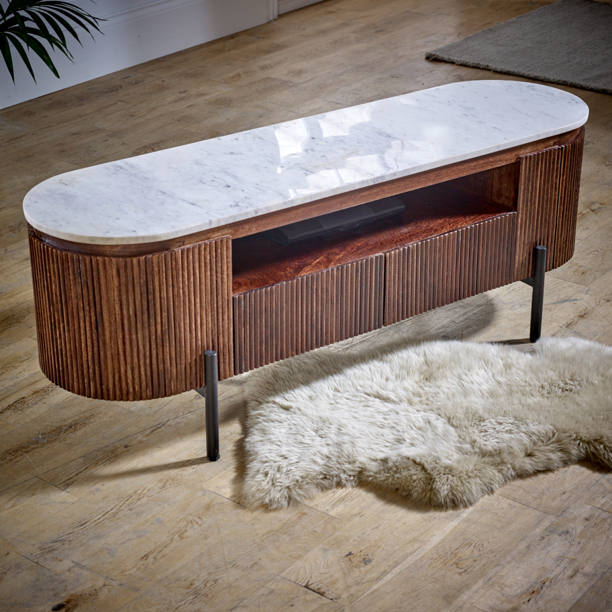 Mango wood TV cabinet with curved white marble top, open media shelf, and black legs