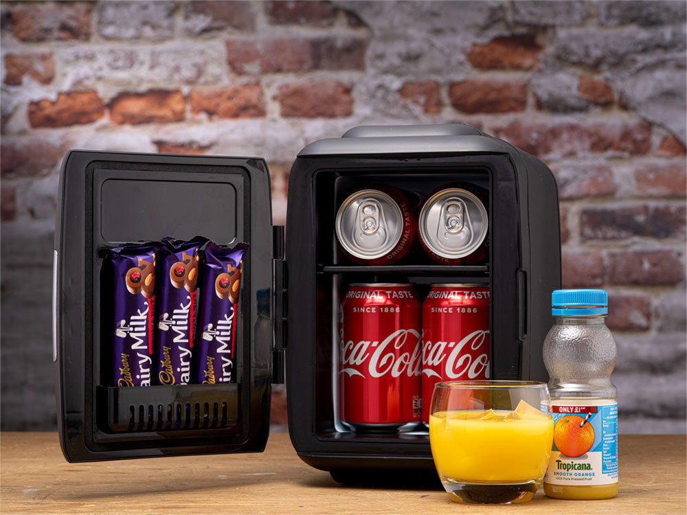 Black mini fridge with open door holding cans, bottles, and packaged snacks