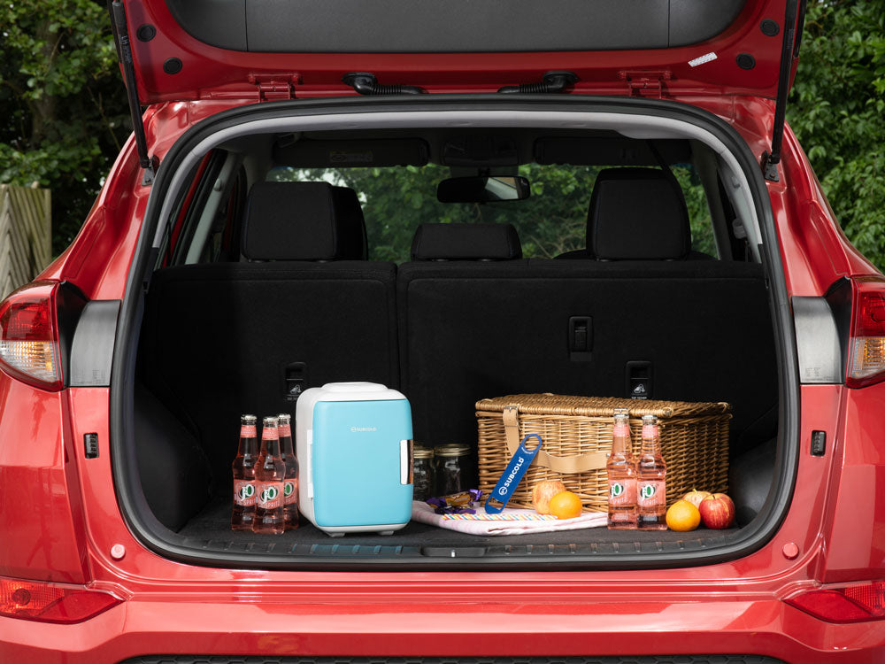 Subcold 4L mini fridge in blue, shown open with drinks and food inside