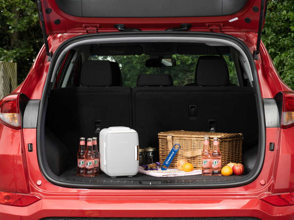 White 4L mini fridge with open door holding drinks, snacks, and small food items.