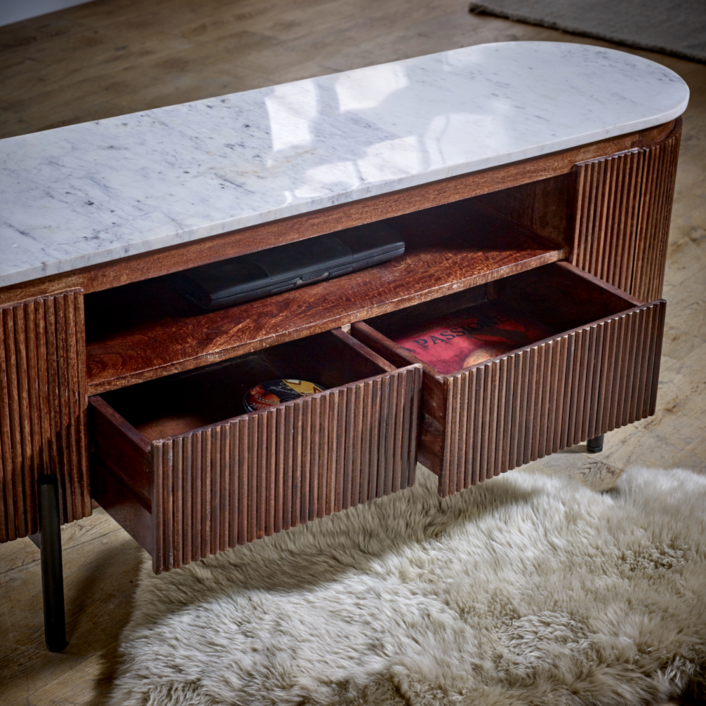 TV cabinet interior with open shelves and ribbed wood panels under a white marble top