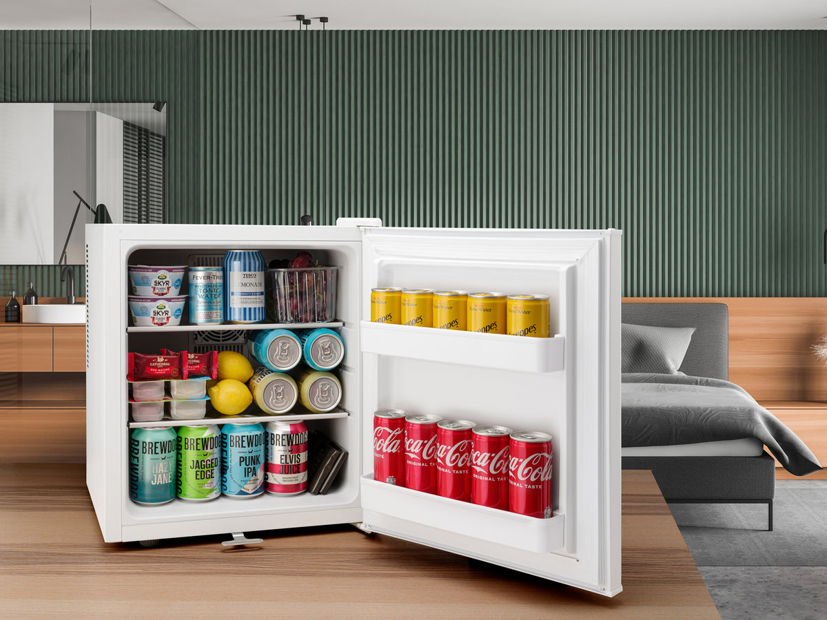 White mini fridge with open door displaying drinks cans and bottles