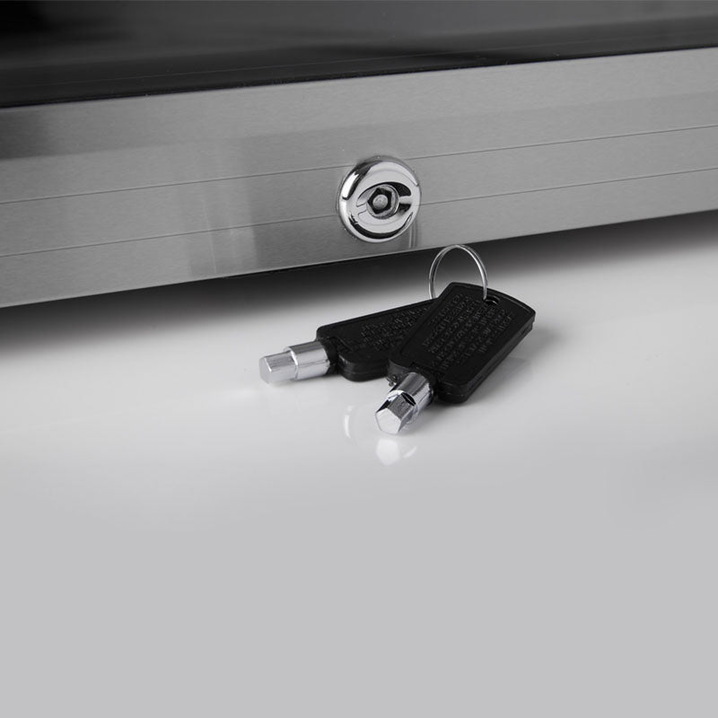 Lock cylinder with keys on top of a stainless drinks fridge