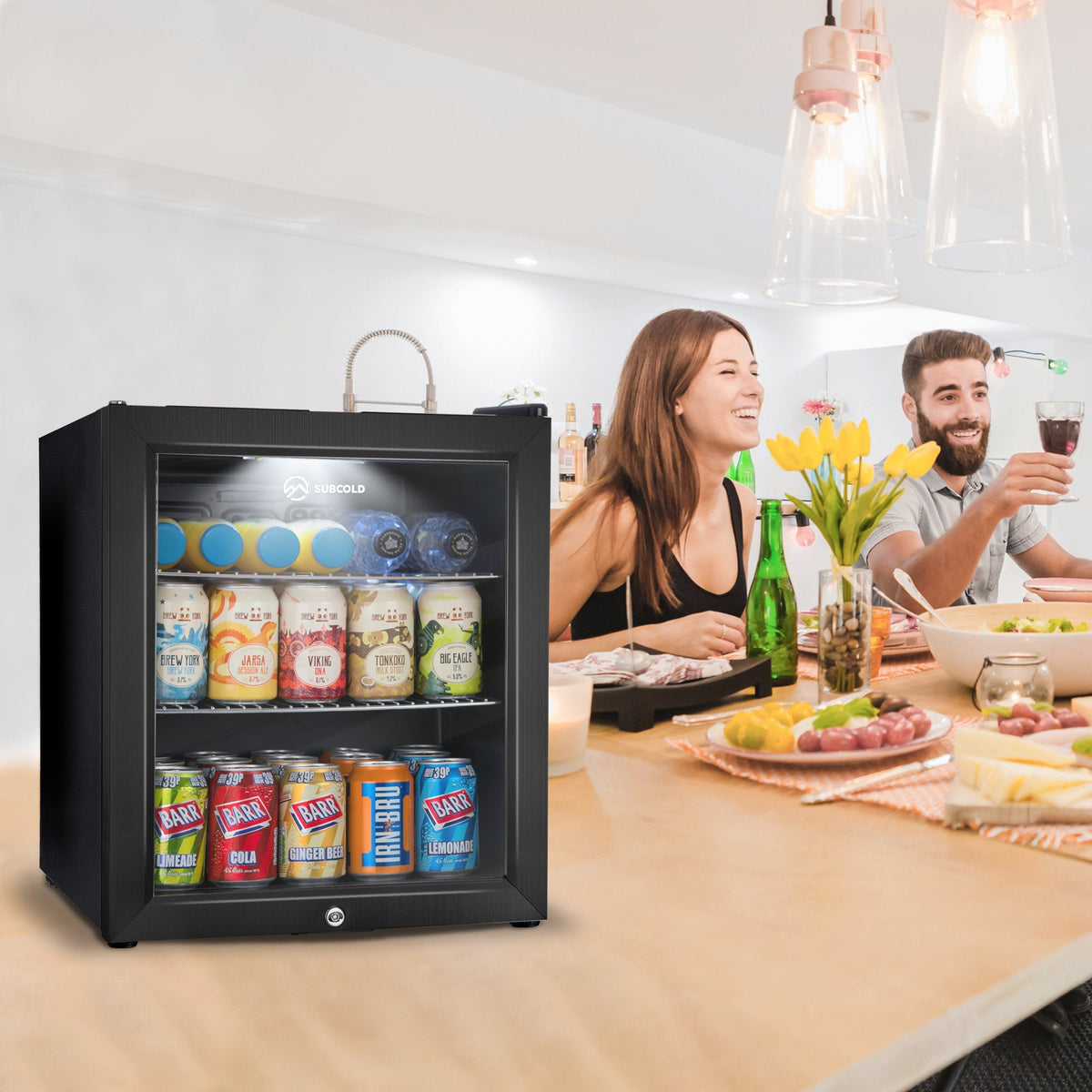 Subcold Super50 LED beer fridge, black glass-door unit stocked with cans, bottles, and jars
