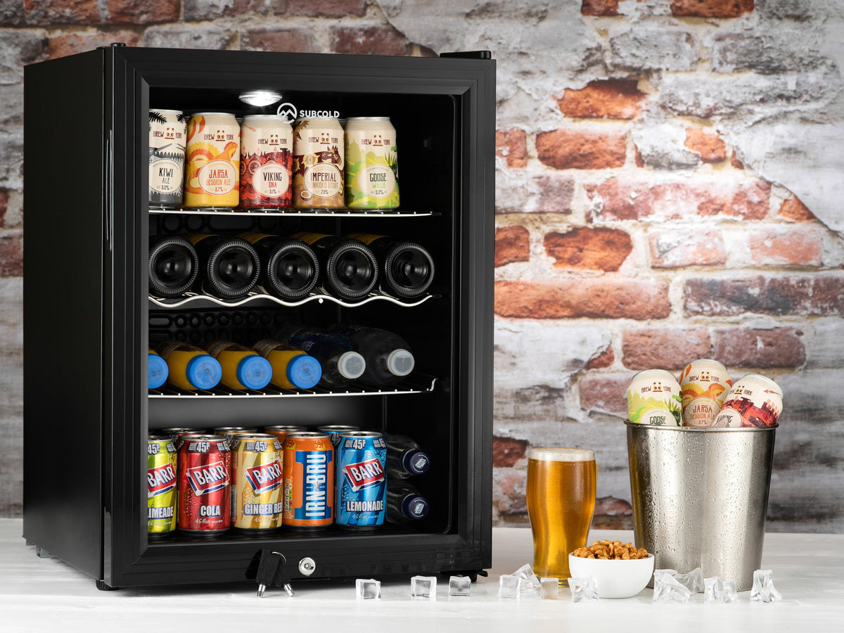 Black drinks fridge with glass door, LED-lit shelves holding cans and bottles