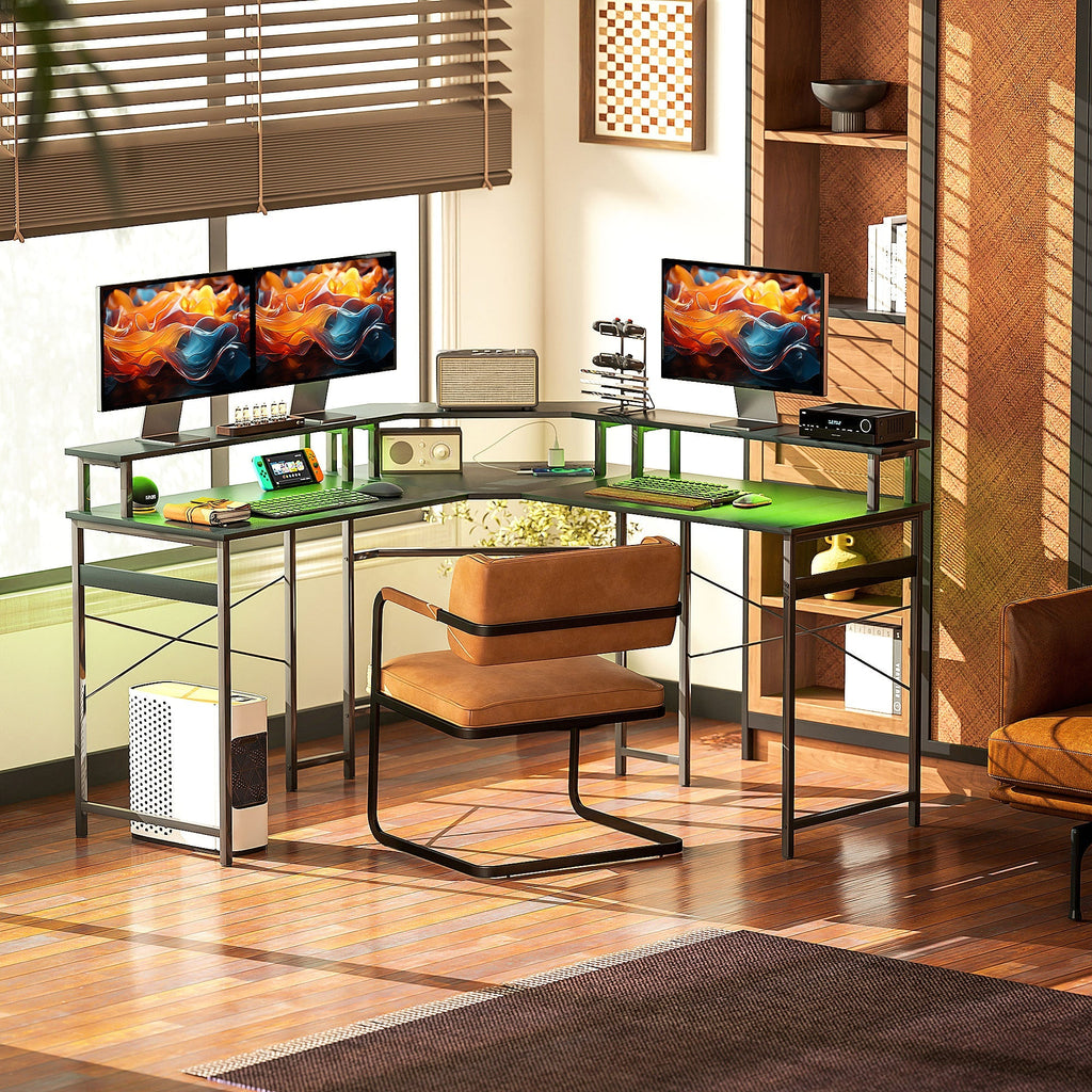 Black L-shaped desk with green LED lighting under the tabletop and metal frame
