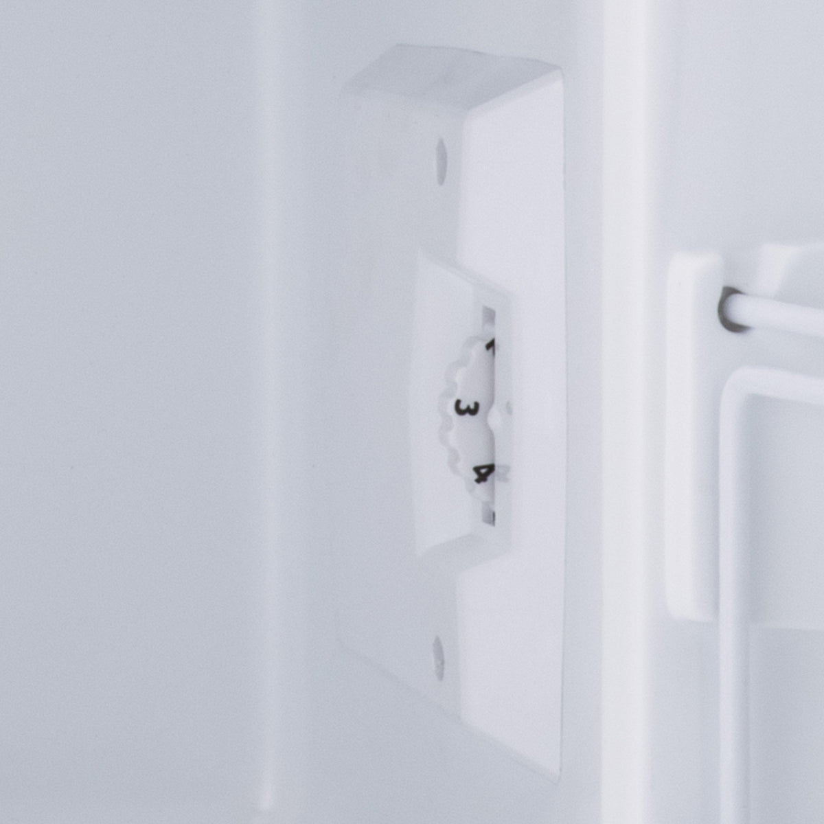 White mini fridge door side panel with built-in power outlet