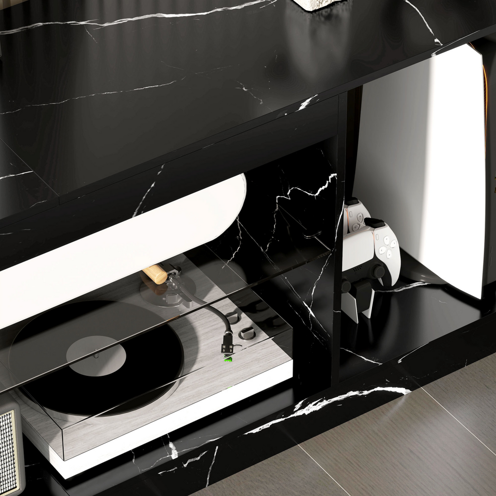 Black marble-effect TV stand interior with glass shelf holding gaming console.