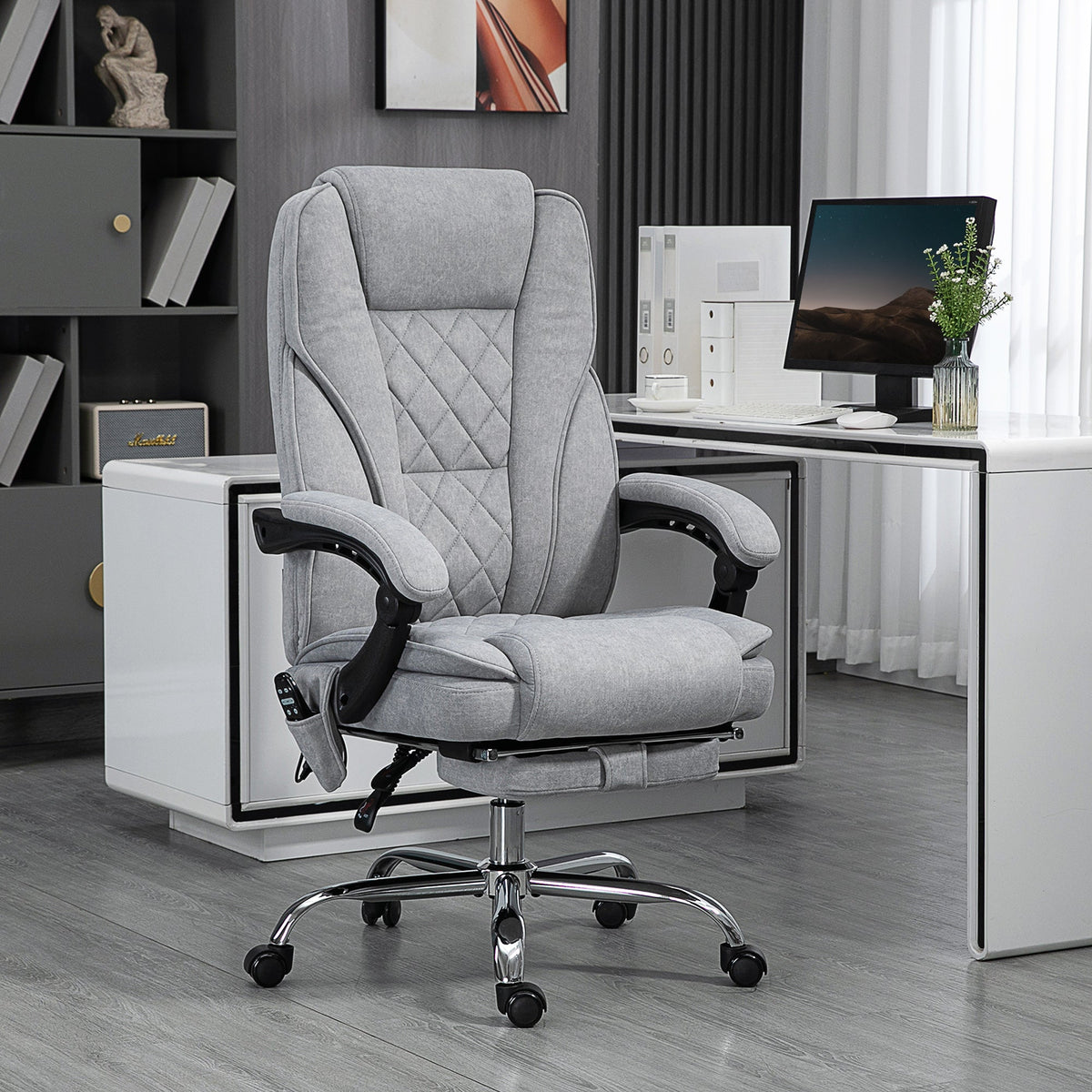 Grey upholstered office massage chair with quilted back and curved padded armrests