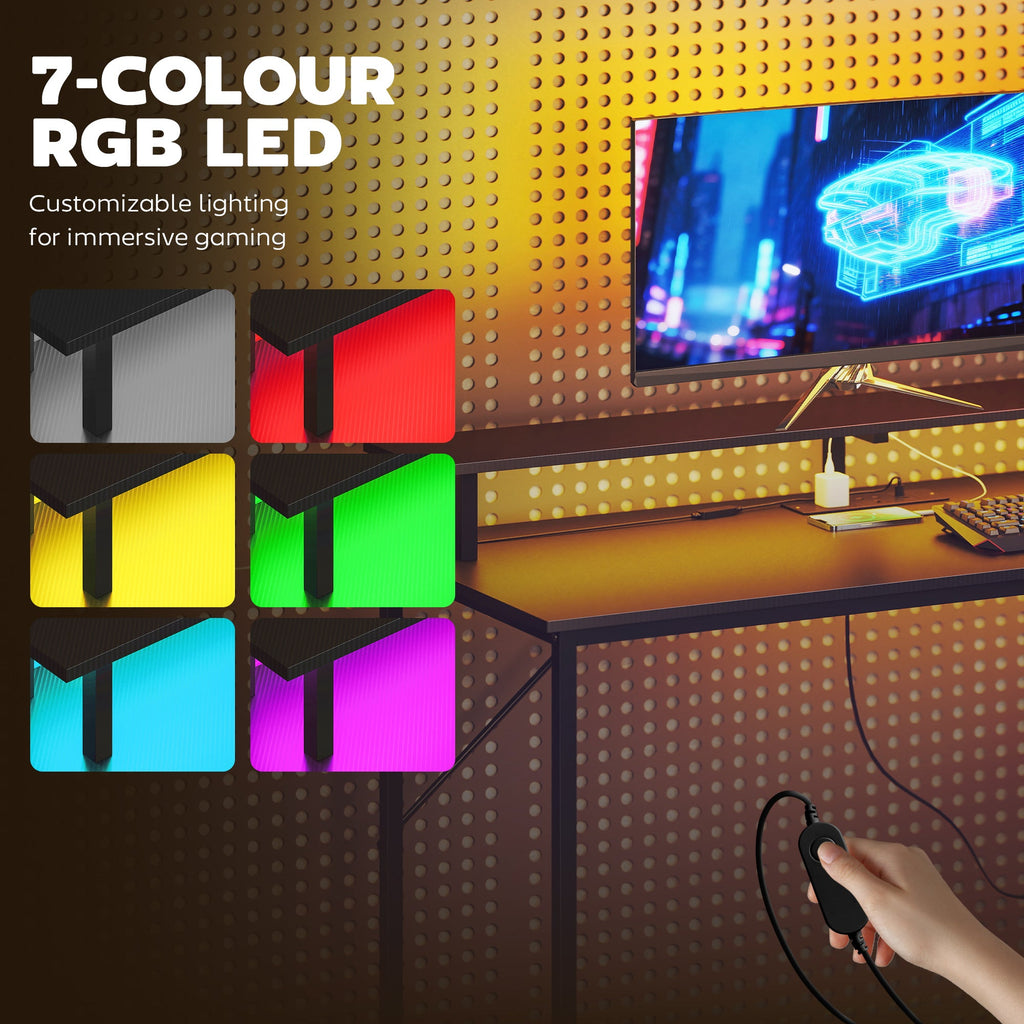 Black pegboard-style gaming desk with 7-color RGB LED lighting and cable