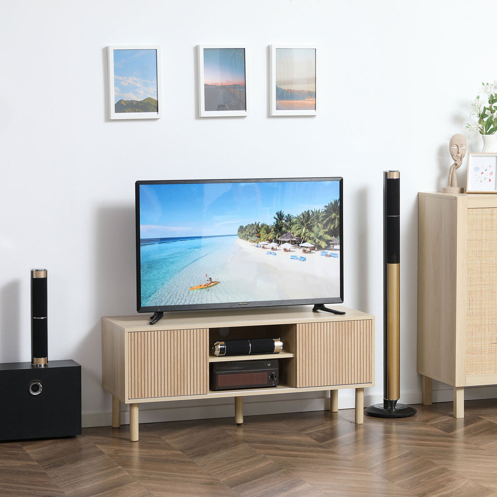 Natural wood TV stand cabinet with sliding doors, center shelves, and TV on top
