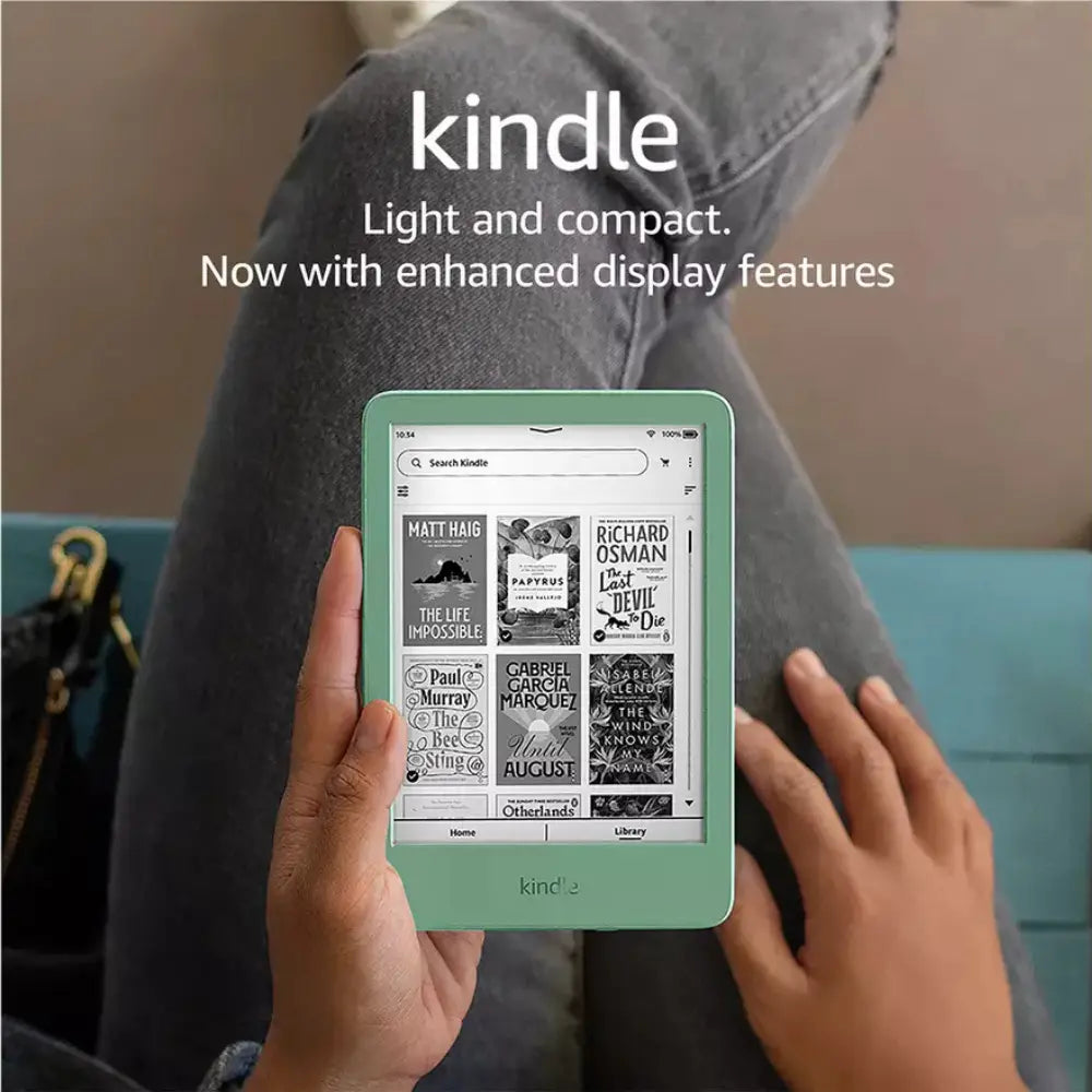 Black Kindle e-reader in hands, green case, showing book list on screen