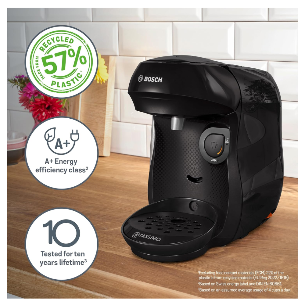 Black coffee pod machine with front tray and cup on the base