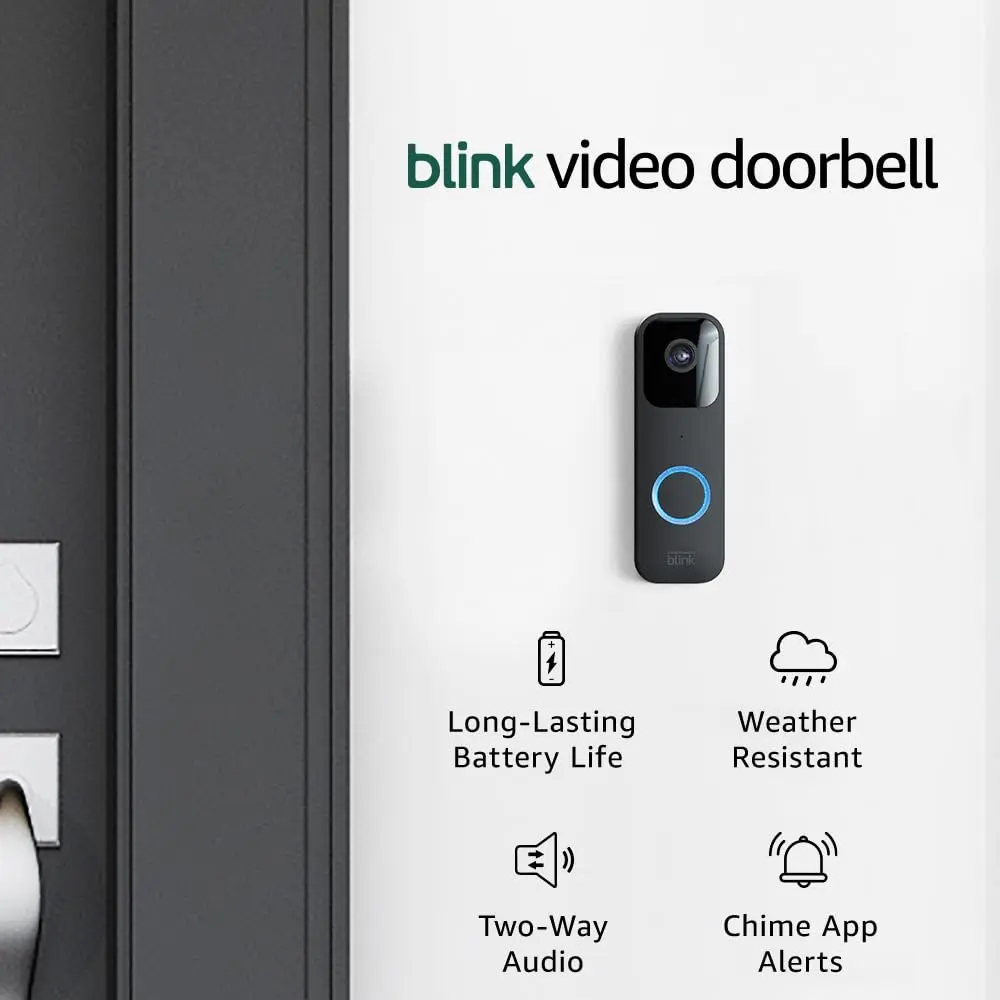 Black video doorbell mounted on a wall with blue illuminated ring