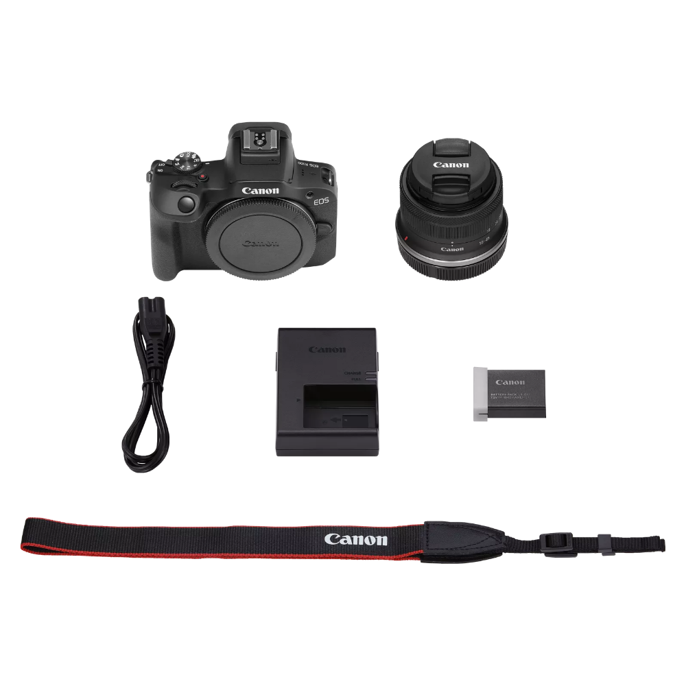 Canon EOS R100 kit items: camera, 18-45mm lens, charger, strap