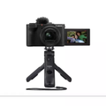Black Canon PowerShot V1 compact camera with rear screen and small tripod stand