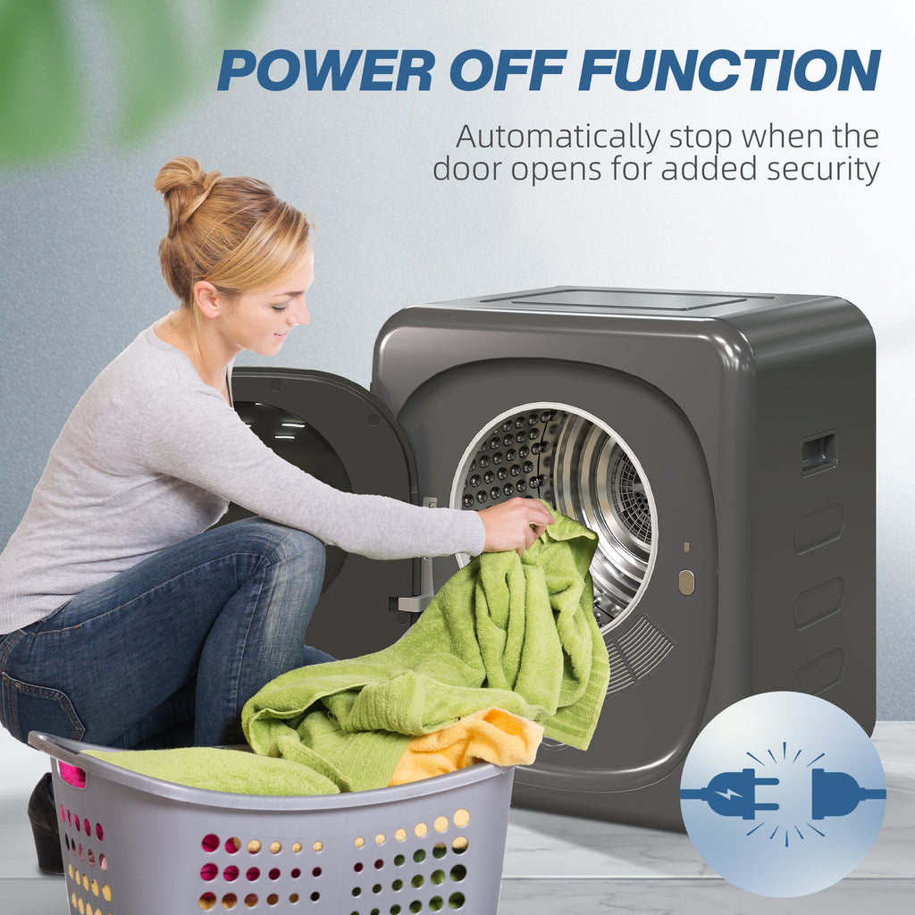 Grey tumble dryer with door open as laundry is loaded into the drum