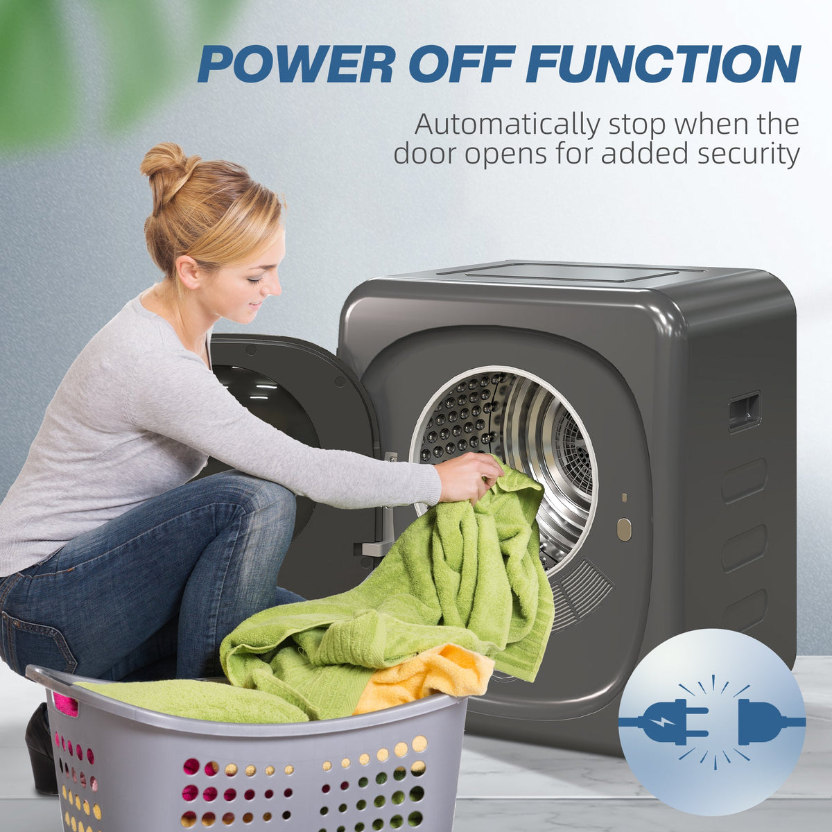 Grey tumble dryer with door open as laundry is loaded into the drum