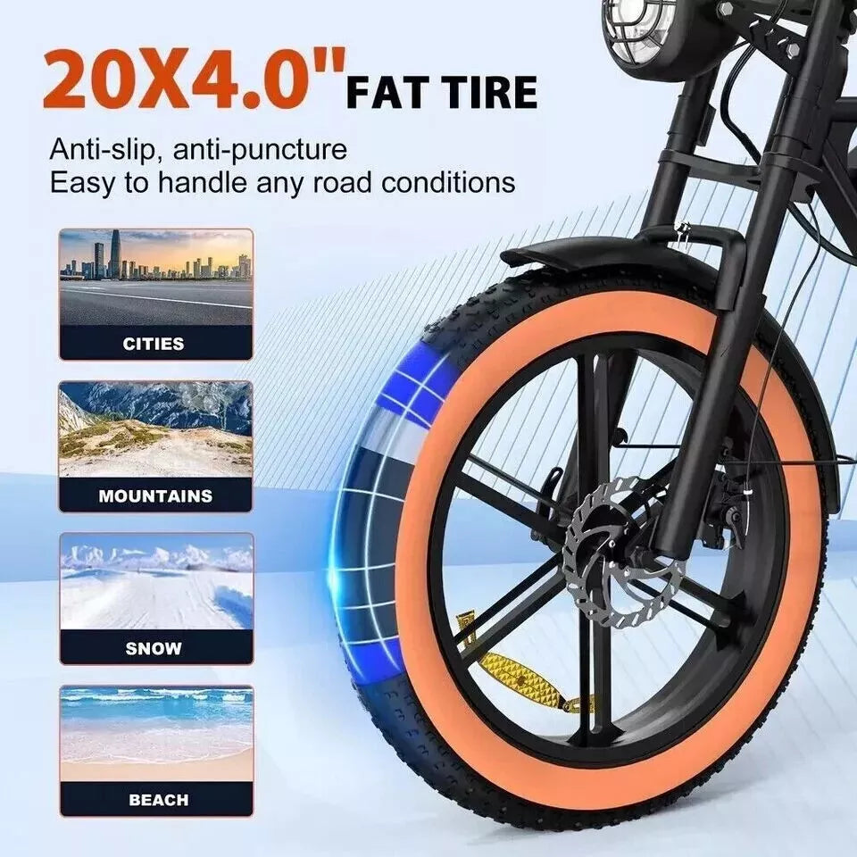 Close view of 4.0" fat front tire on an orange-accented electric bike.