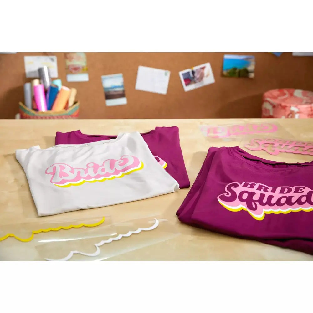 Set of branded shirts on a work surface, purple and white designs