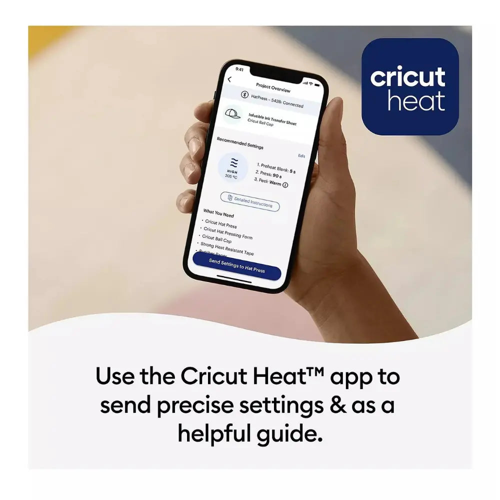 Hand holding smartphone with Cricut Heat settings screen