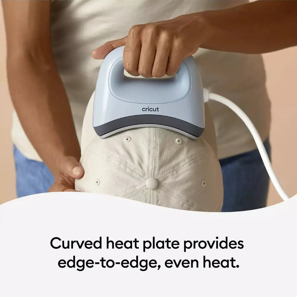 Cricut hat press with curved heat plate pressing a light fabric cap