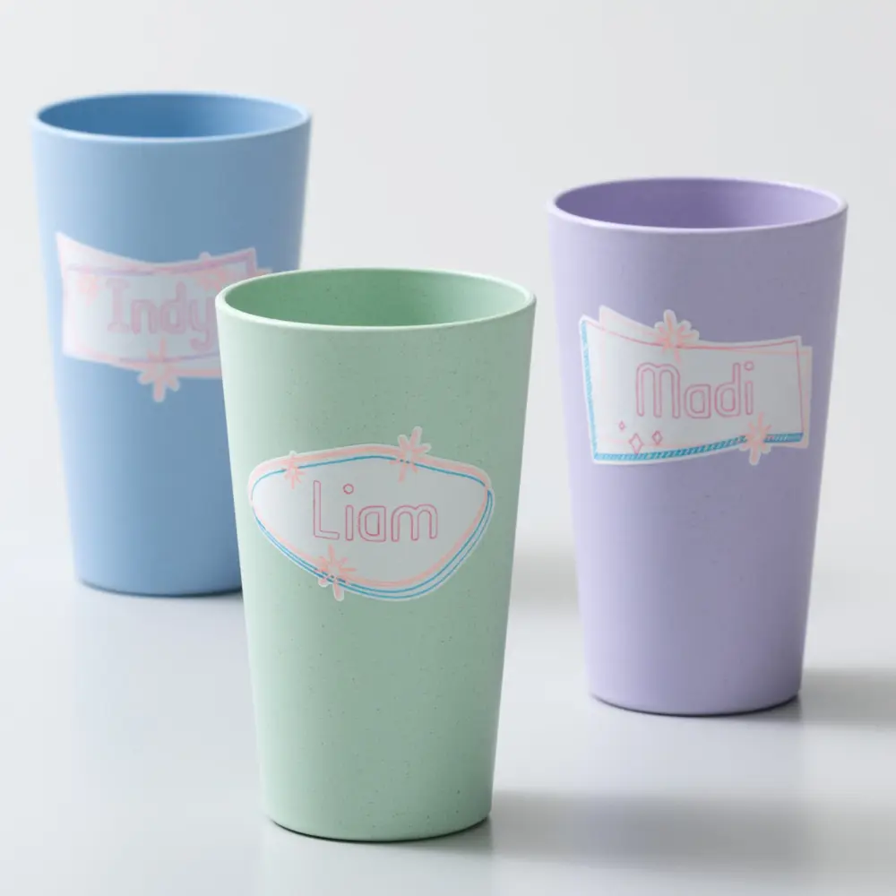 Dissolvable Smart LabelTM paper prints on tumblers in green, blue, and purple
