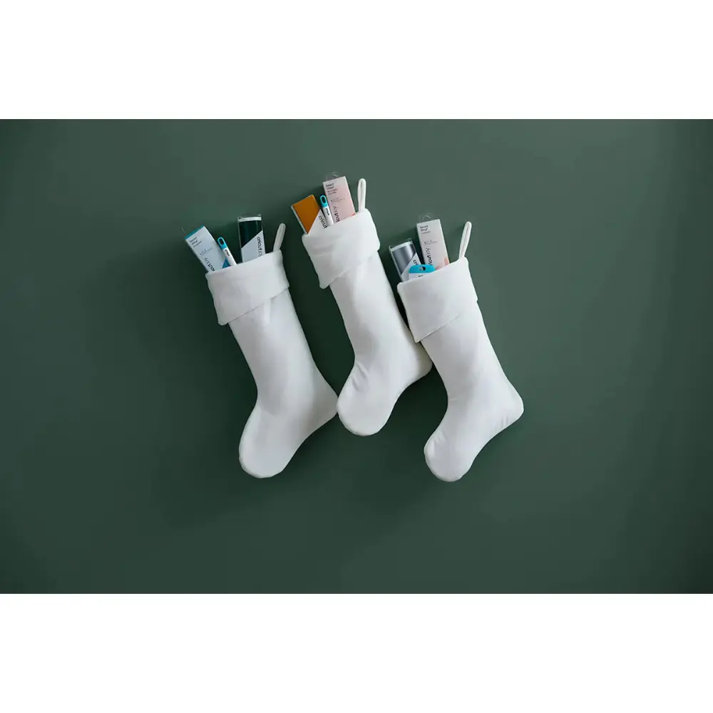 Set of white tool sleeves with teal-and-white Cricut labels hanging on green wall