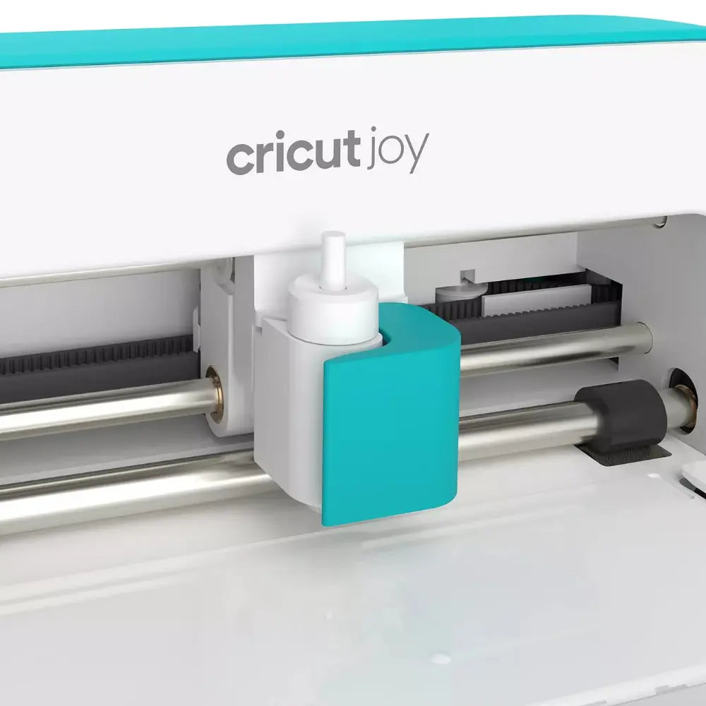 Cricut Joy cutting carriage with turquoise tool holder and feed rollers