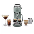 Green DELONGHI espresso machine with dual spouts, cups, and milk jug