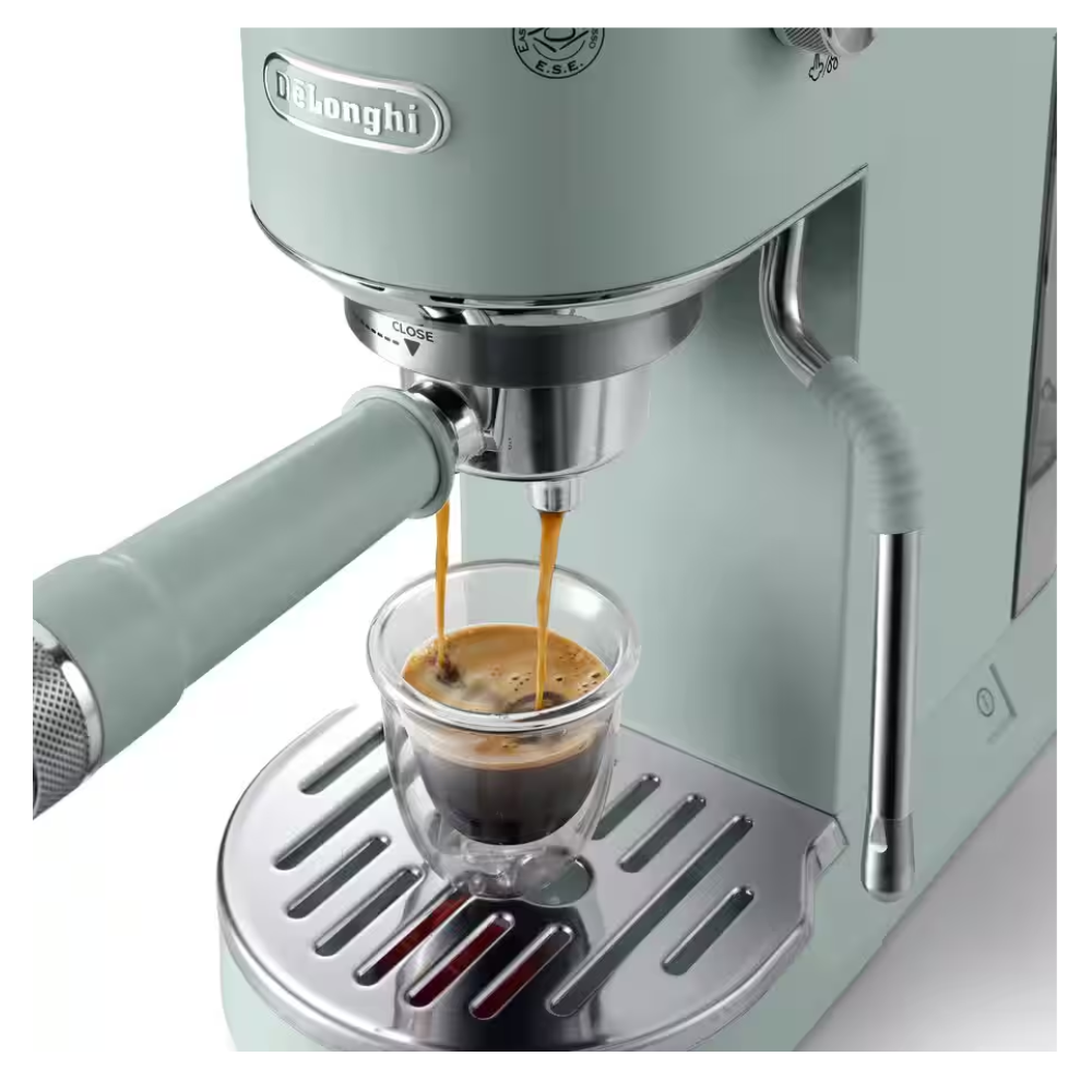 Green DELONGHI espresso machine brewing espresso into a glass cup