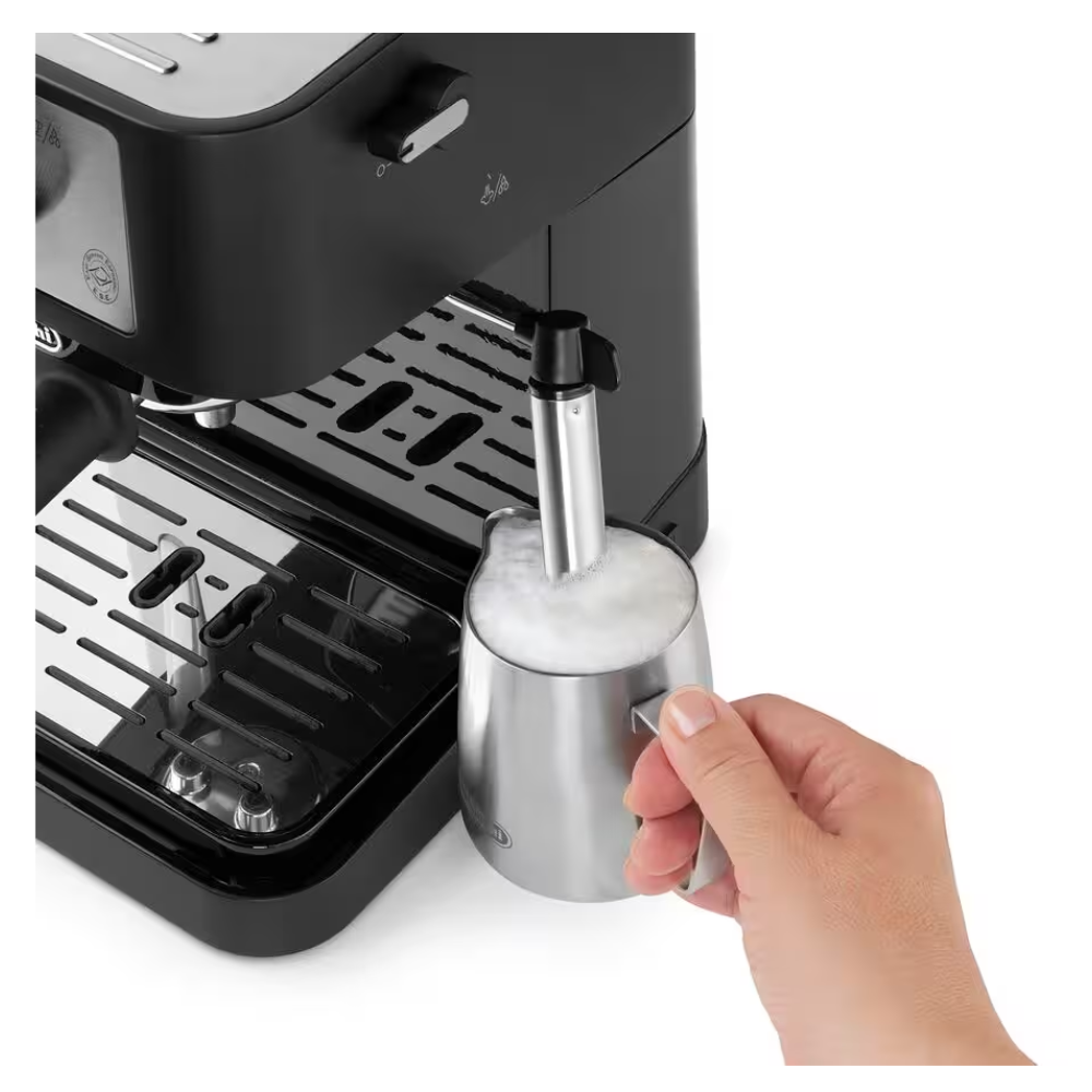 Stainless milk pitcher under steam wand on Delonghi espresso machine