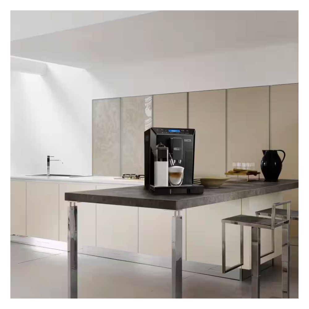 Automatic bean-to-cup coffee machine on kitchen counter with cup and carafe