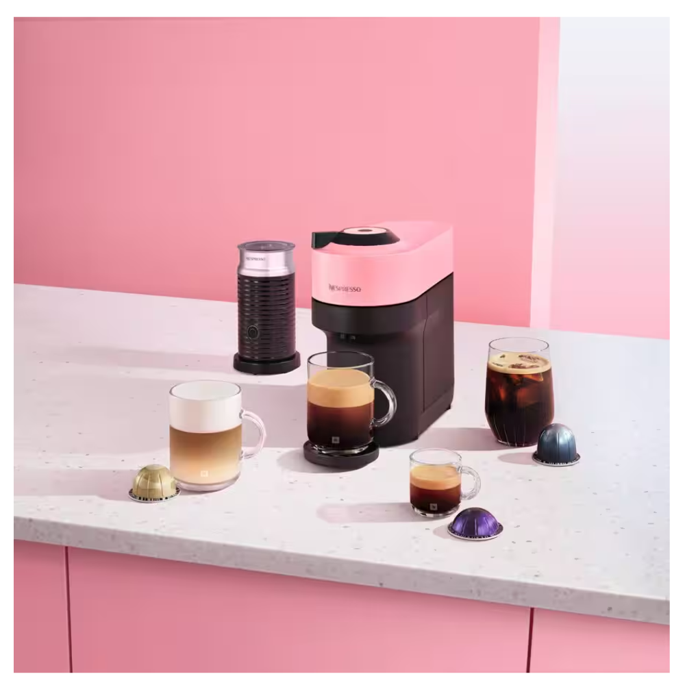 DELONGHI VERTUO POP Nespresso machine in candy pink and black on countertop with cups