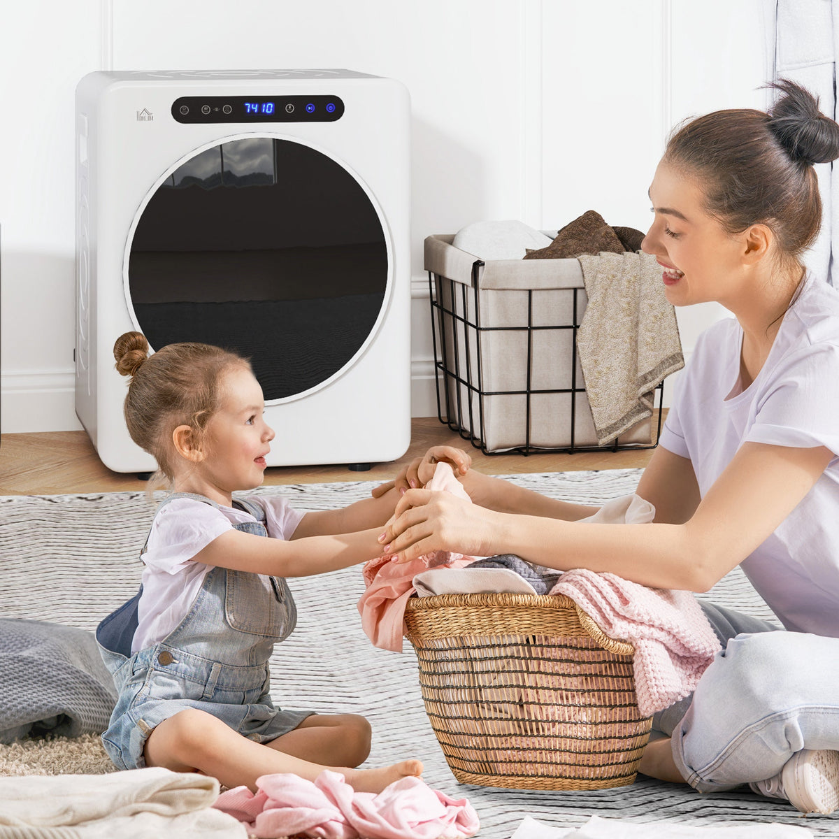 White compact vented tumble dryer with round door as a child unloads laundry