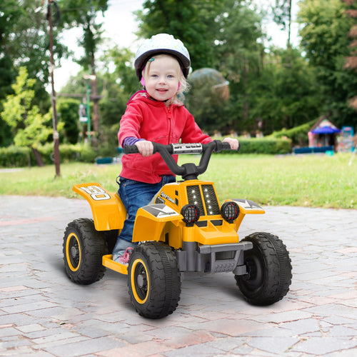 Yellow electric kids quad bike with gray seat and black tires, ridden by a child.