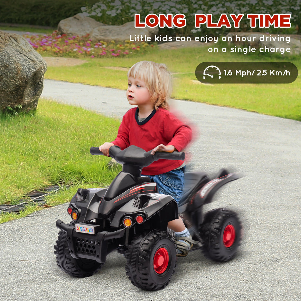 Black kids electric quad bike with large knobby tires and front lights