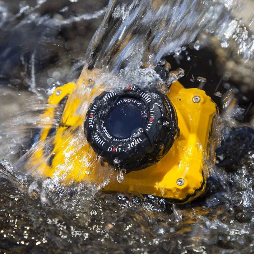 Waterproof yellow digital camera with lens visible under splashing water